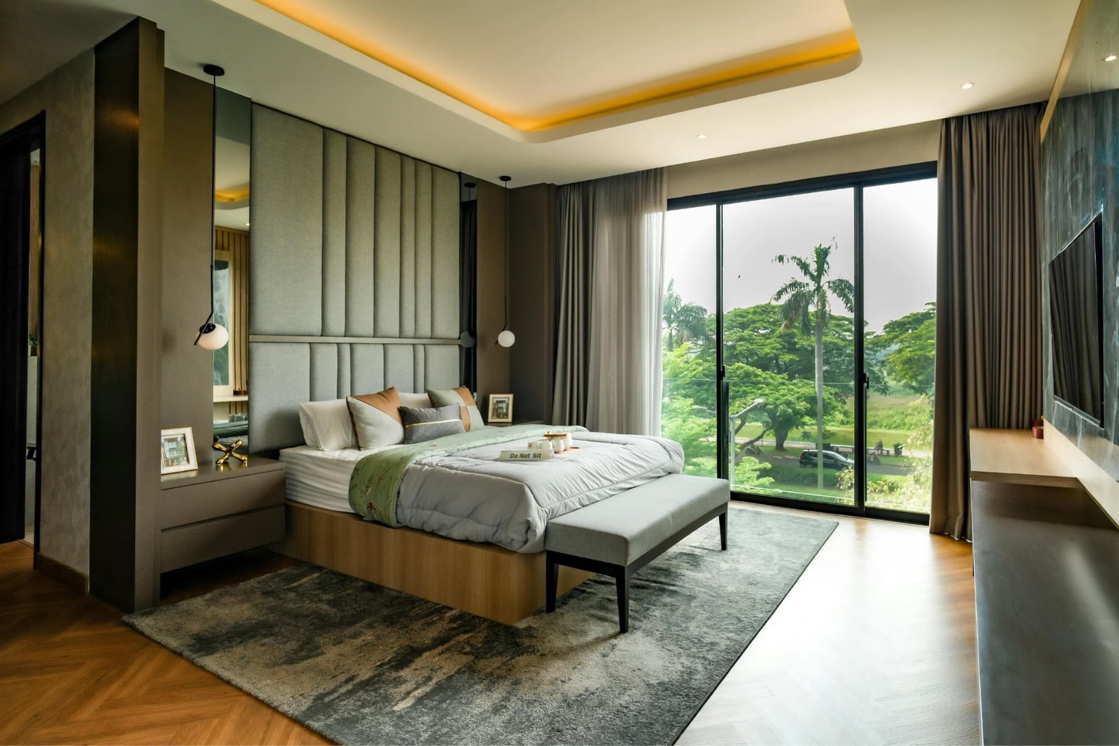 Serene bedroom styled with layered textiles and a garden view