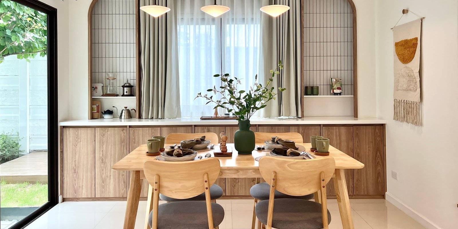 Scandinavian dining nook with an oak table and soft green accents